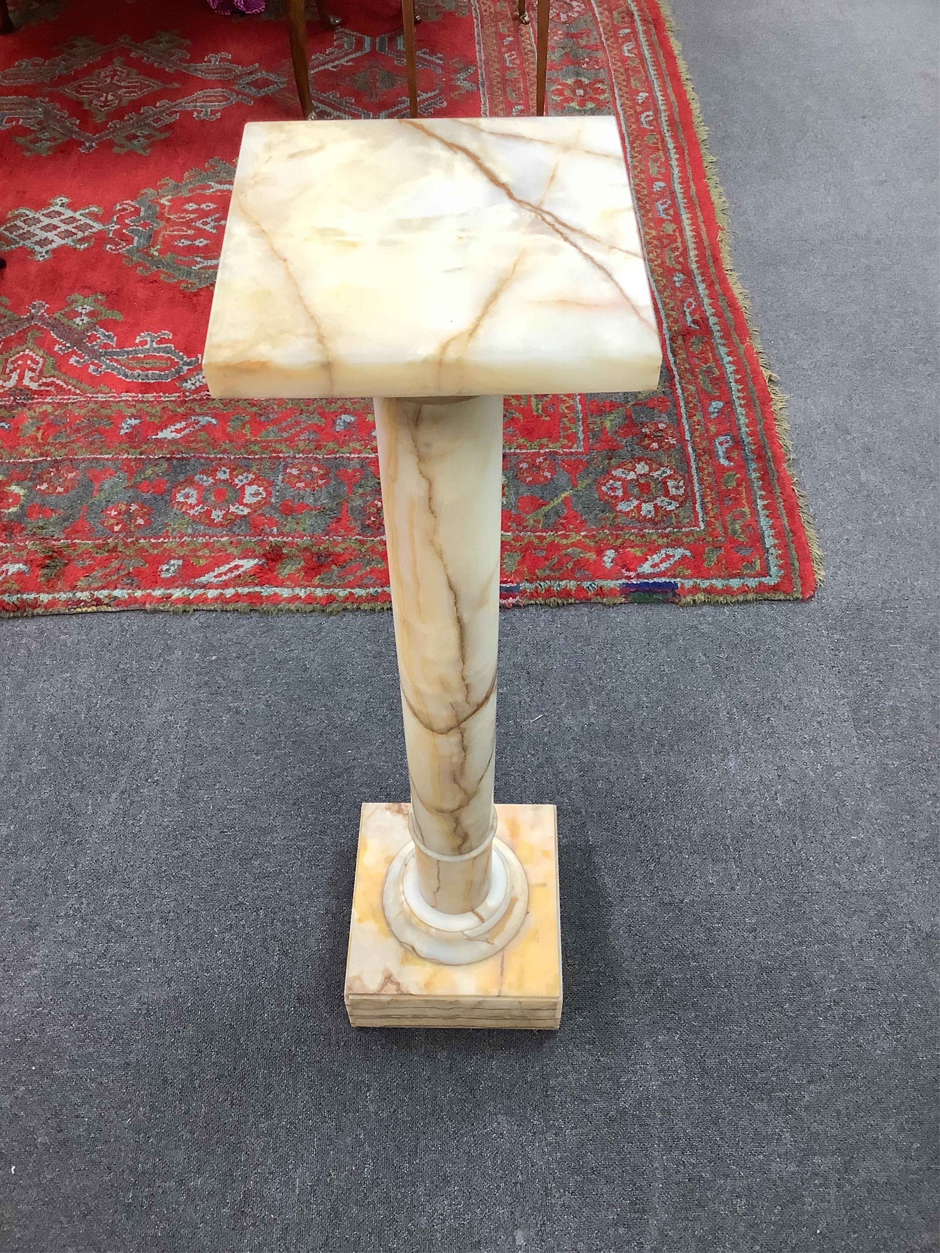 An early 20th century onyx pedestal column, height 106cm. Condition - fair to good, some minor chipping.